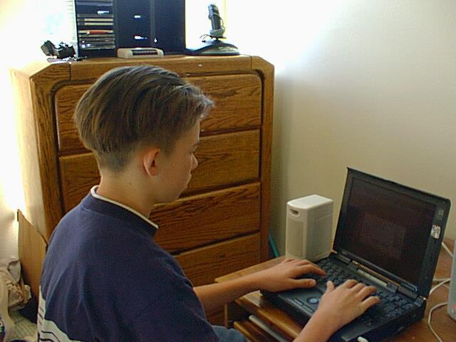 Young programmer coding on laptop